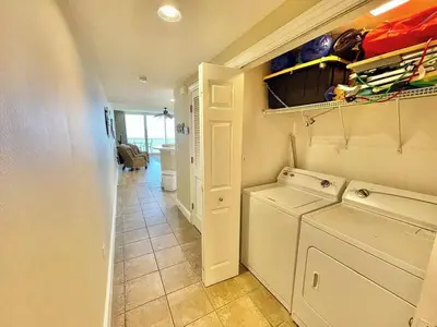 a laundry room with a washer and dryer at Majestic Beach Towers 2-2107 by Emerald Coast Retreats in Panama City Beach