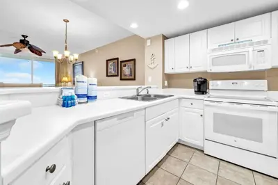 a kitchen with white cabinets and a sink at Majestic Beach Towers 2-2107 by Emerald Coast Retreats in Panama City Beach
