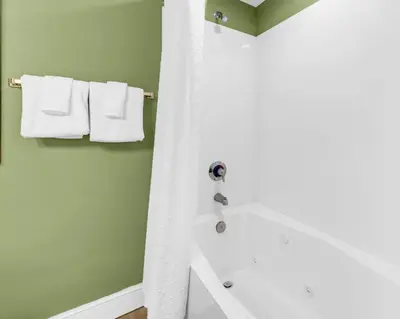 a bathroom with a white shower curtain and a tub at Majestic Beach Towers 2-2107 by Emerald Coast Retreats in Panama City Beach