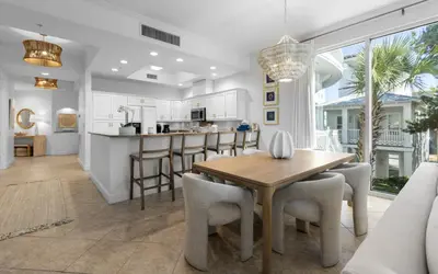 a kitchen and dining room with a table and chairs at Sunset Oasis on 30A in Rosemary Beach