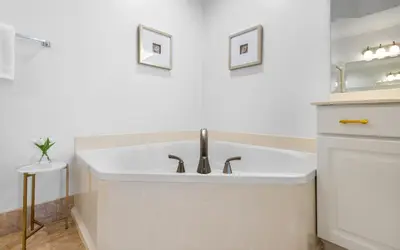 a white bathroom with a sink and a mirror at Sunset Oasis on 30A in Rosemary Beach