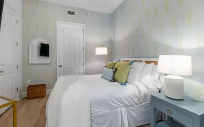 a bedroom with a white bed and two lamps at Sunset Oasis on 30A in Rosemary Beach