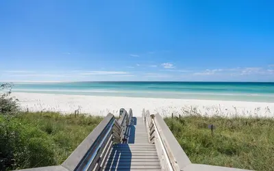 a staircase leading to a beach with the ocean at Sunset Oasis on 30A in Rosemary Beach