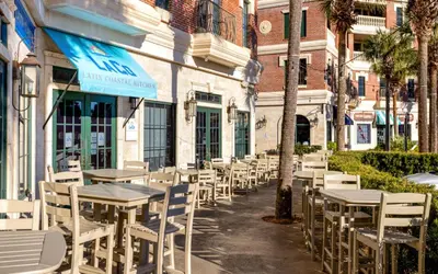 a row of tables and chairs in front of a building at Sunset Oasis on 30A in Rosemary Beach