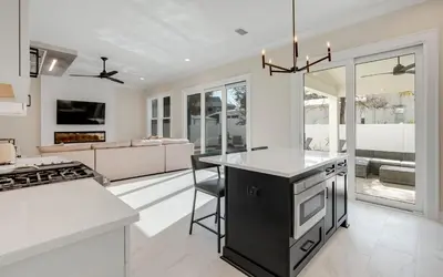 a kitchen with a black and white counter top at Sunny Cove in Santa Rosa Beach