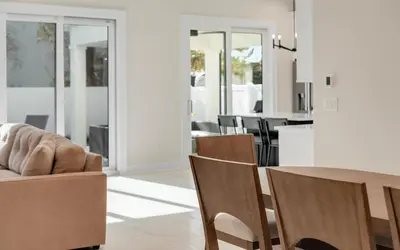 a dining room and living room with a table and chairs at Sunny Cove in Santa Rosa Beach