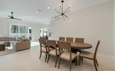 a dining room with a table and chairs and a couch at Sunny Cove in Santa Rosa Beach
