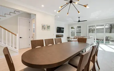 a dining room with a wooden table and chairs at Sunny Cove in Santa Rosa Beach
