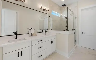 a white bathroom with two sinks and a large mirror at Sunny Cove in Santa Rosa Beach