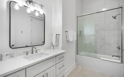 a white bathroom with a sink and a shower at Magnolia Way in Santa Rosa Beach