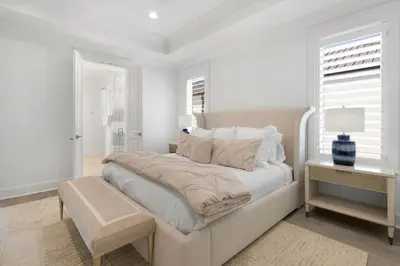 a white bedroom with a large bed and a window at Magnolia Way in Santa Rosa Beach