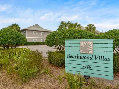 a sign for beachwood villas in front of a house at Skinny Dip- Renovated Unit- Steps to the beach in Santa Rosa Beach