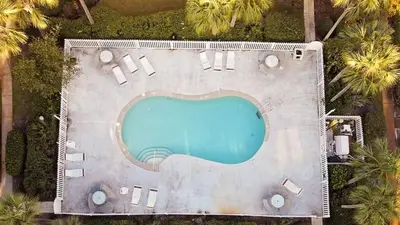 an overhead view of a swimming pool at a resort at Skinny Dip- Renovated Unit- Steps to the beach in Santa Rosa Beach