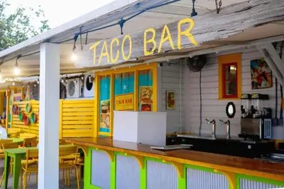 a taco bar with tables and chairs in front of it at Skinny Dip- Renovated Unit- Steps to the beach in Santa Rosa Beach