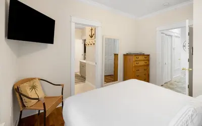 a bedroom with a bed and a television on a wall at Bluesunshine in Santa Rosa Beach