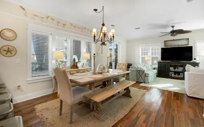 a dining room with a table and a couch at Bluesunshine in Santa Rosa Beach