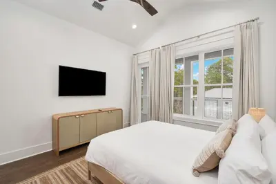 a white bedroom with a bed and a window at Gulfside Hideaway in Santa Rosa Beach