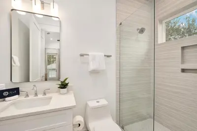 a bathroom with a shower and a toilet and a sink at Gulfside Hideaway in Santa Rosa Beach