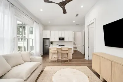 a living room with a couch and a kitchen at Gulfside Hideaway in Santa Rosa Beach