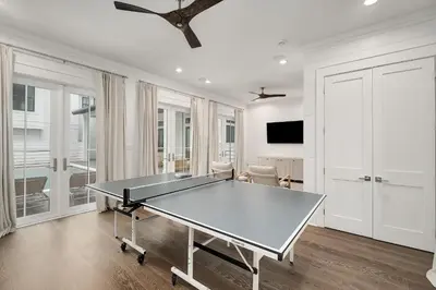 a dining room with a ping pong table in it at Gulfside Hideaway in Santa Rosa Beach