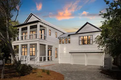 a white house with a garage at Gulfside Hideaway in Santa Rosa Beach