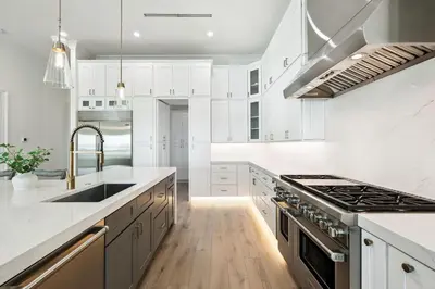 a white kitchen with a sink and a stove at Gather at the Gulf in Inlet Beach