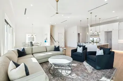 a living room with a couch and a table at Gather at the Gulf in Inlet Beach