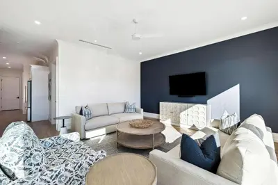 a living room with a couch and a table at Gather at the Gulf in Inlet Beach