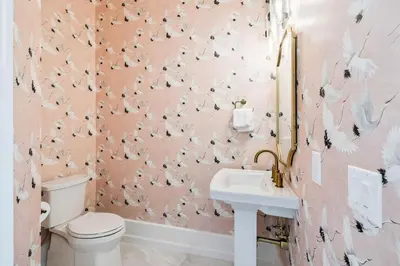 a pink bathroom with a toilet and a sink at Gather at the Gulf in Inlet Beach