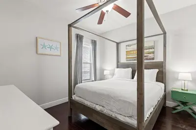a bedroom with a canopy bed with a mirror at 30A Beach House with Golf Cart - Whatcha Dune in Inlet Beach