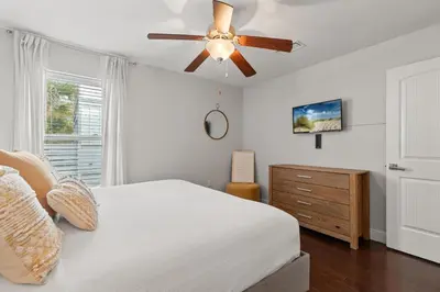 a bedroom with a bed and a ceiling fan at 30A Beach House with Golf Cart - Whatcha Dune in Inlet Beach