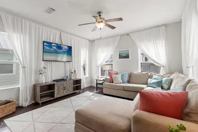 a living room with a couch and a ceiling fan at 30A Beach House with Golf Cart - Whatcha Dune in Inlet Beach