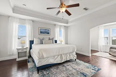 a bedroom with a bed and a ceiling fan at 30A Beach House with Golf Cart - Whatcha Dune in Inlet Beach