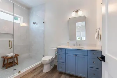 a bathroom with a toilet and a sink and a shower at Wine Down in Panama City Beach