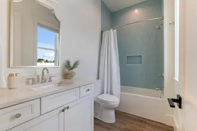 a bathroom with a toilet and a sink and a shower at Wine Down in Panama City Beach