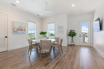 a dining room with a table and chairs at Wine Down in Panama City Beach