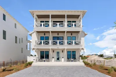 a large white house with a balcony at Wine Down in Panama City Beach