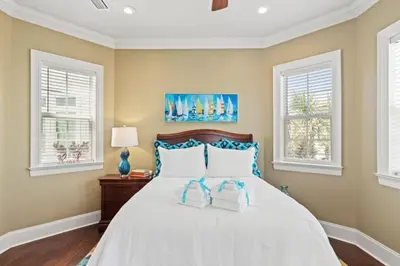 a bedroom with a bed with two towels on it at Poseidon's Grotto in Santa Rosa Beach