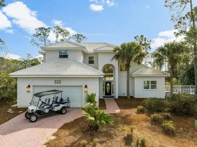 a golf cart parked in front of a house at Somerset by the Sea by Travel Life Vacations in Santa Rosa Beach