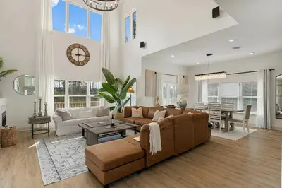 a living room with a couch and a table at Somerset by the Sea by Travel Life Vacations in Santa Rosa Beach