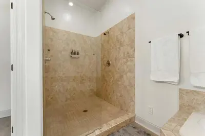 a bathroom with a shower with a glass door at Somerset by the Sea by Travel Life Vacations in Santa Rosa Beach