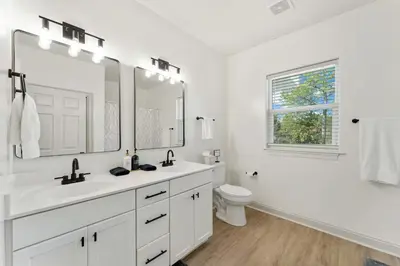 a white bathroom with a sink and a toilet at Somerset by the Sea by Travel Life Vacations in Santa Rosa Beach