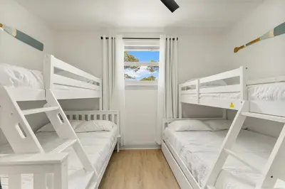 two bunk beds in a white room with a window at Somerset by the Sea by Travel Life Vacations in Santa Rosa Beach