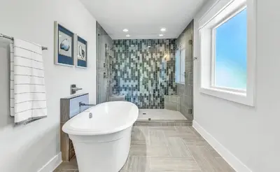a white bathroom with a toilet and a shower at Luxury by the Sea by Travel Life Vacations in Santa Rosa Beach