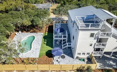 an aerial view of a house with a swimming pool at Luxury by the Sea by Travel Life Vacations in Santa Rosa Beach