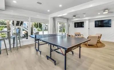 a dining room with a ping pong table in it at Luxury by the Sea by Travel Life Vacations in Santa Rosa Beach