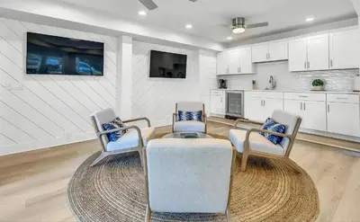 a living room with two chairs and a table at Luxury by the Sea by Travel Life Vacations in Santa Rosa Beach