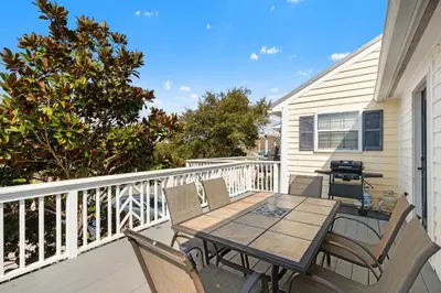 a patio with a table and chairs on a balcony at Gulf Vista Condominiums in Seacrest