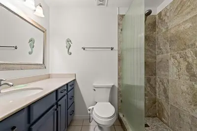 a bathroom with a toilet and a sink and a shower at Gulf Vista Condominiums in Seacrest