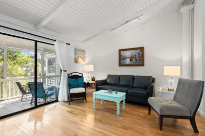 a living room with a couch and a table at Gulf Vista Condominiums in Seacrest